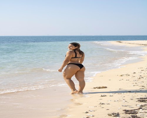 Persona relajada tomando café y estirándose suavemente por la mañana en su departamento en México